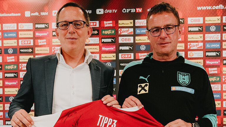 tipp3-Geschäftsführer Philip Newald (links) und ÖFB-Teamchef Teamchef Ralf Rangnick (rechts) halten ein Team-Trikot vor sich