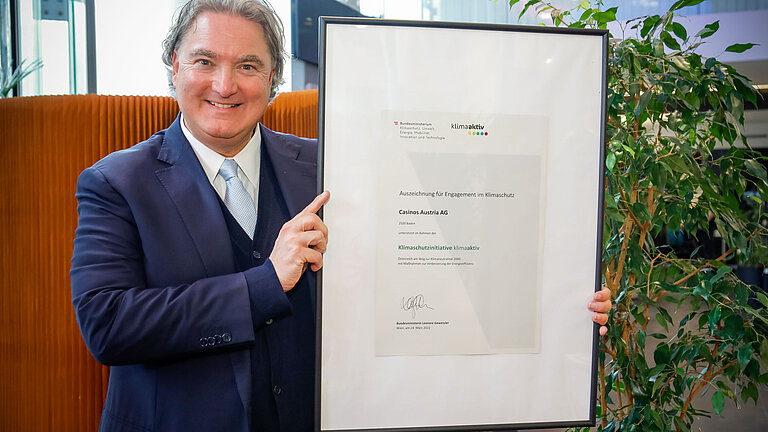 Director General Erwin van Lambaart displays the framed certificate.