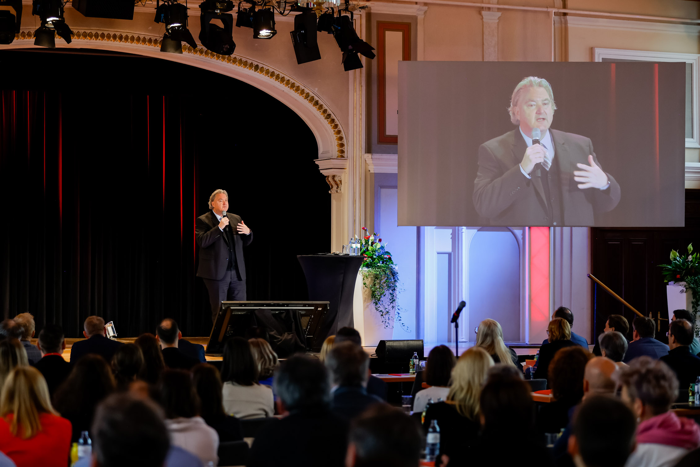 The Director General addresses guests on the stage of the Casino Baden.
